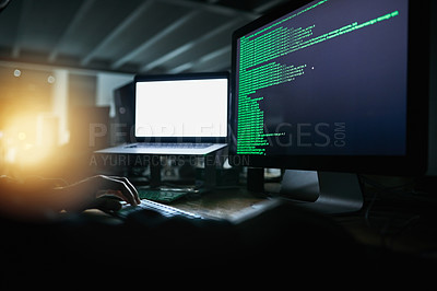 Buy stock photo Shot of an unrecognizable computer hacker hacking into a computer network late at night