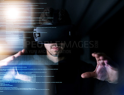 Buy stock photo Shot of a young computer programmer wearing a vr headset while working on his code