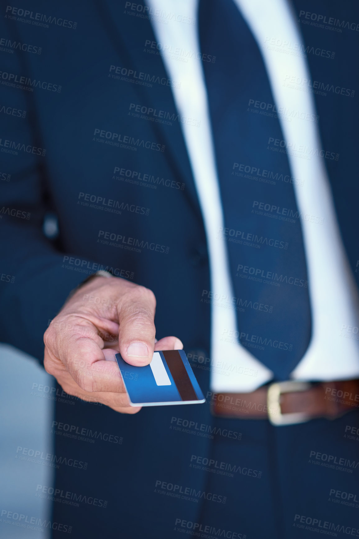 Buy stock photo Cropped shot of an unrecognisable businessman holding a credit card