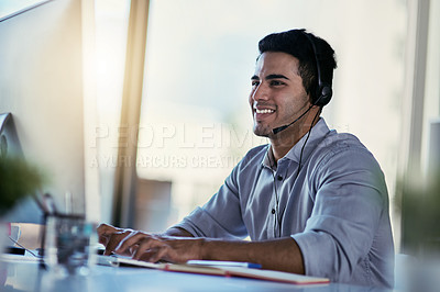 Buy stock photo Customer support agent, smile and man in office consulting with advice, crm and happiness at work. Happy phone call, conversation and telecom help desk consultant speaking into headset at computer.
