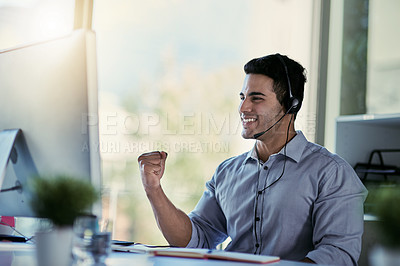 Buy stock photo Callcenter agent, smile and winning, man with advice, celebration and happiness at help desk. Happy phone call, conversation and success, customer support consultant speaking into headset in office.