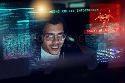 Buy stock photo Shot of a young hacker cracking a computer code in the dark