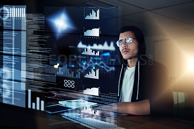 Buy stock photo Shot of a young hacker cracking a computer code in the dark