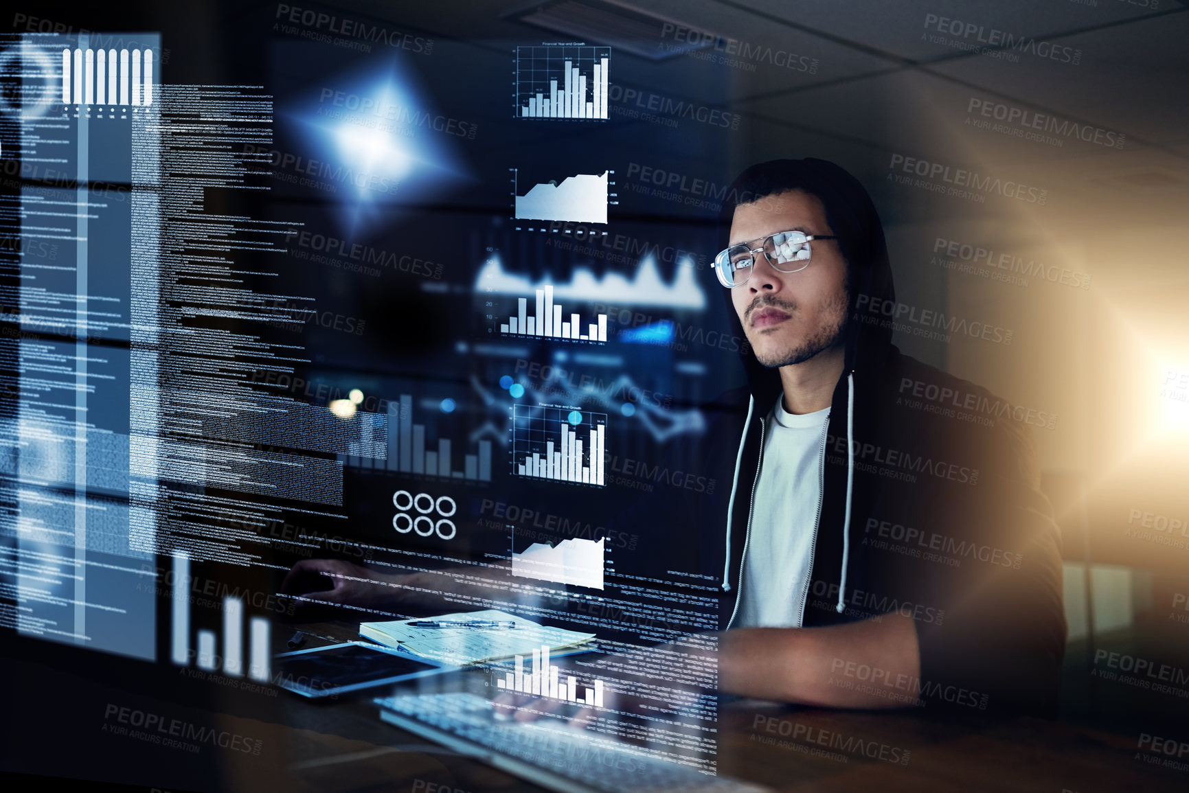 Buy stock photo Shot of a young hacker cracking a computer code in the dark