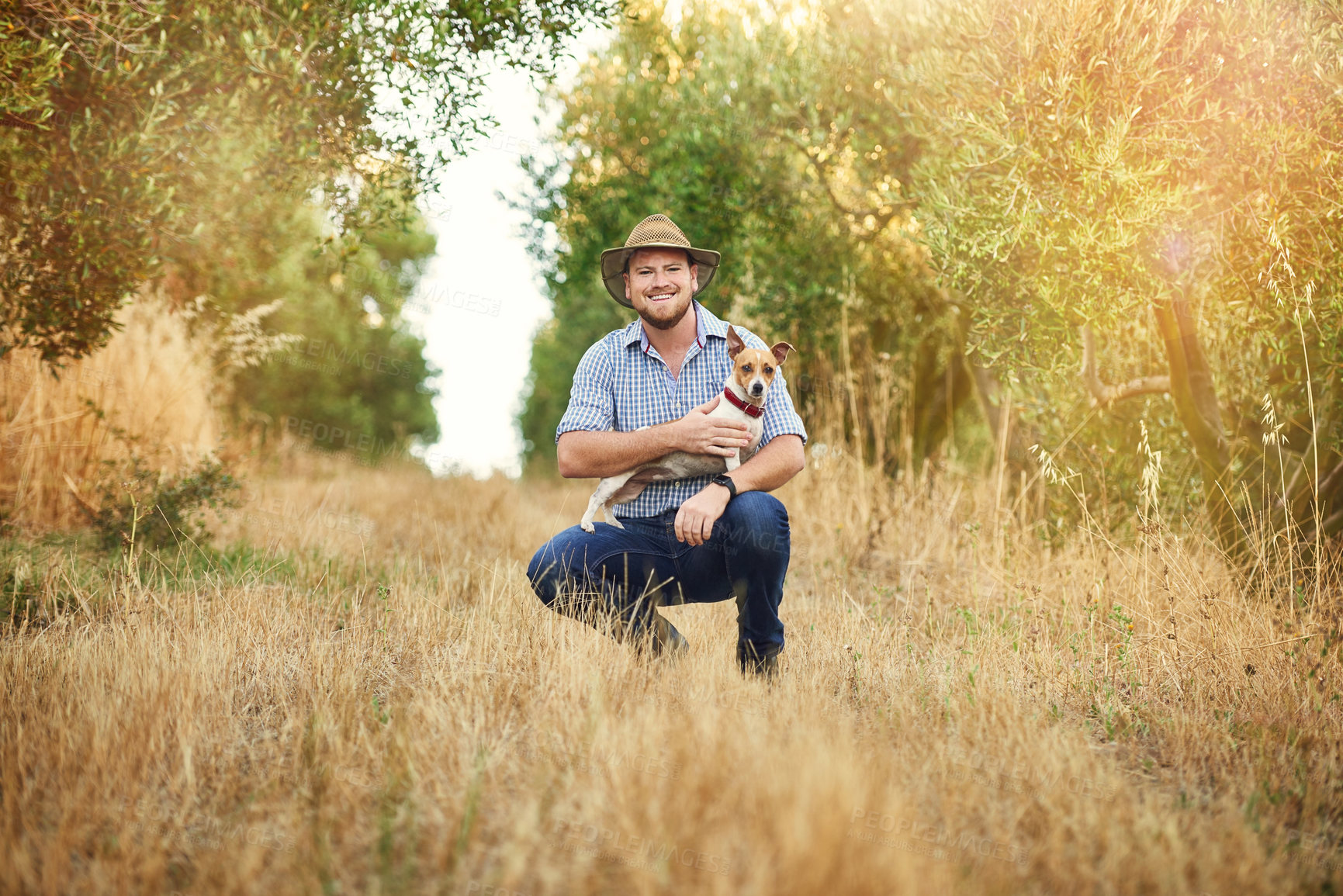 Buy stock photo Shot of a happy farmer holding his dog
