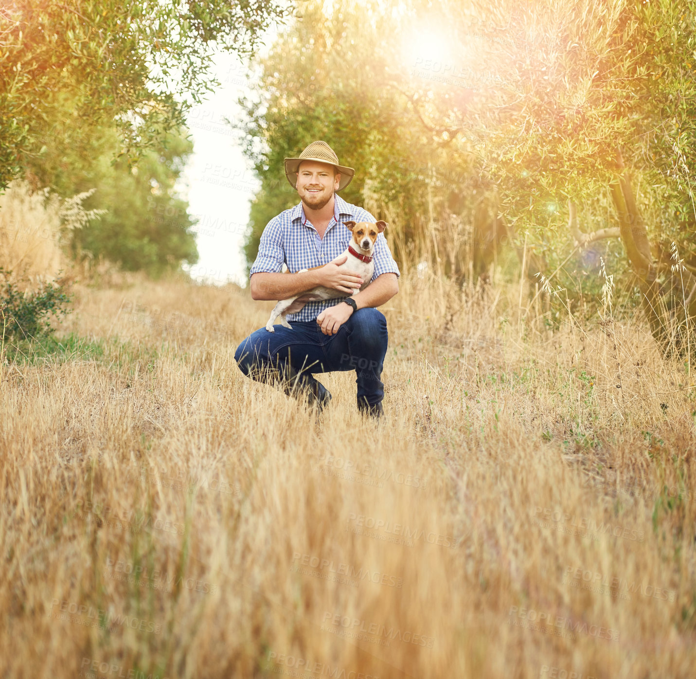 Buy stock photo Shot of a happy farmer holding his dog