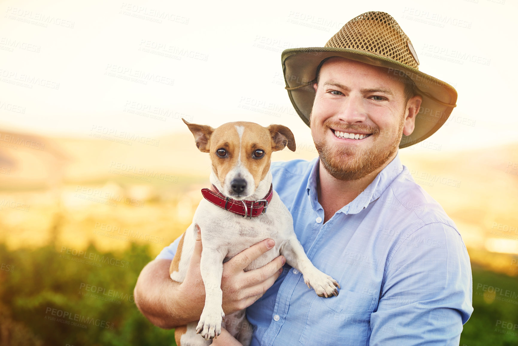 Buy stock photo Shot of a happy farmer holding his dog