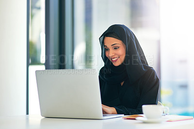 Buy stock photo Shot of a young muslim businesswoman using a laptop at her work desk