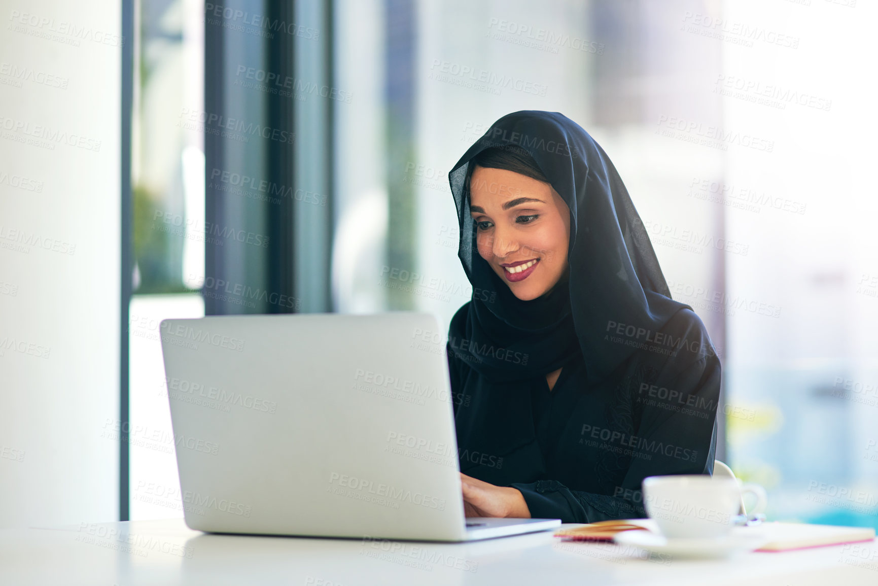 Buy stock photo Happy woman, muslim and laptop with hijab at office for communication, email or connection. Islam, female person or employee with smile or scarf on computer for online browsing or web at workplace