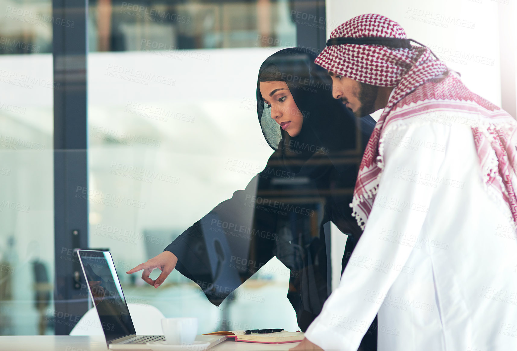 Buy stock photo Business people, muslim and pointing at laptop screen in office for consult, advice or client. Meeting, hijab woman and man with keffiyeh for asset management, planning or idea at Investment bank