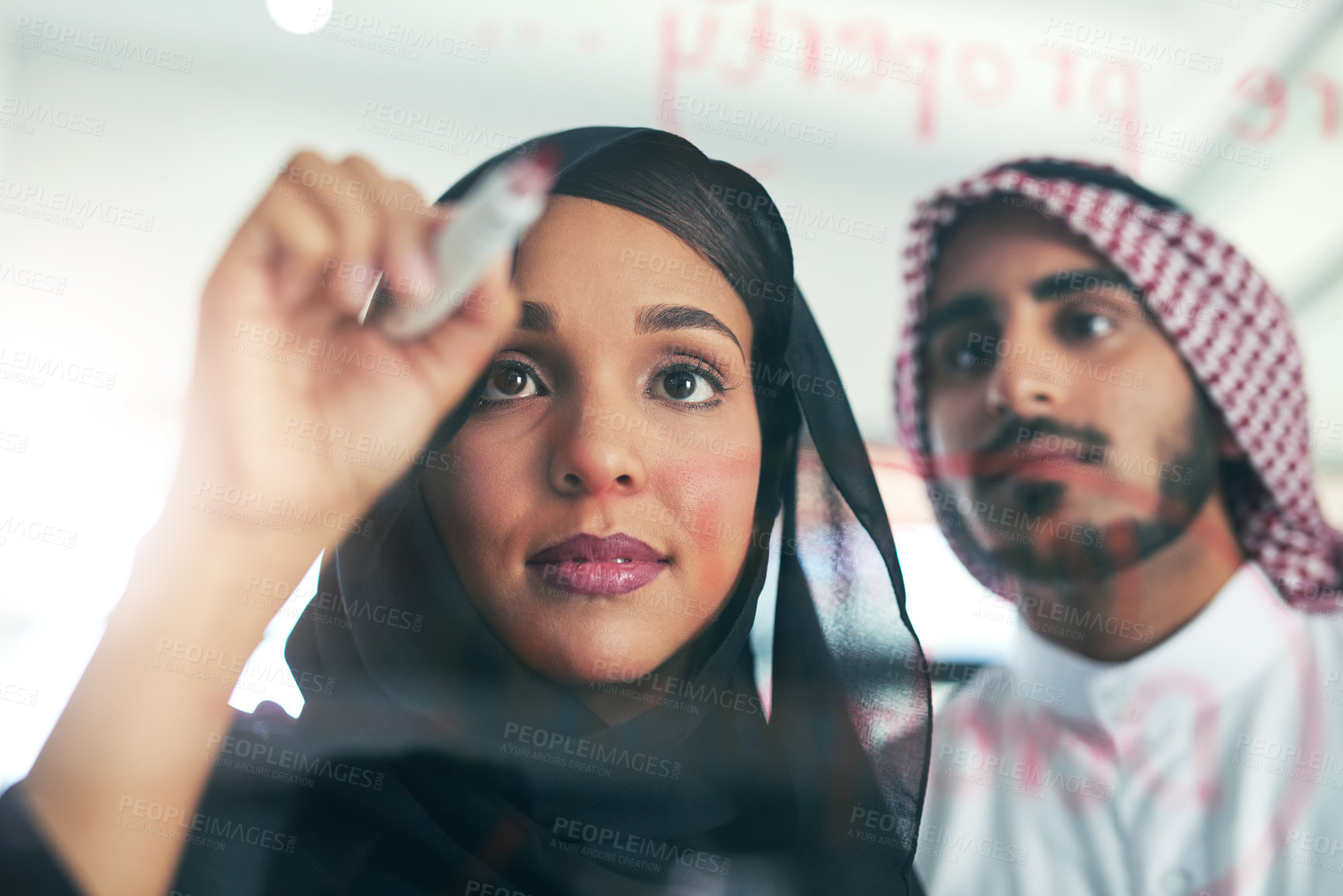 Buy stock photo Arab, businesspeople and writing on glass, strategy and meeting for our vision for Dubai property company for planning. Muslim employee, development and collaboration, innovation and brainstorming