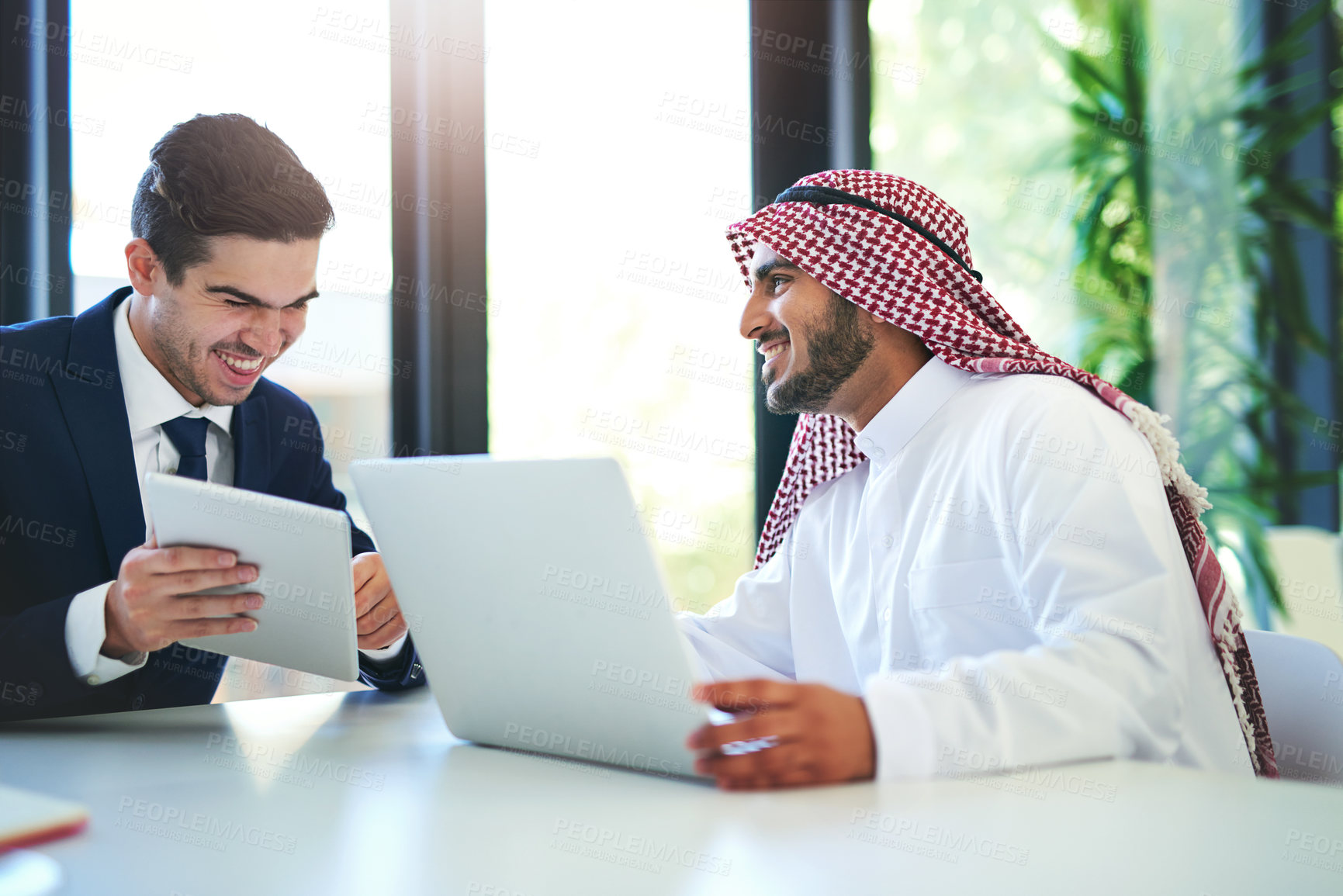 Buy stock photo Muslim, employee and laptop in office for teamwork, discussion and partnership for b2b collaboration. Diversity, vision and man coworker for online project, professional communication in Dubai