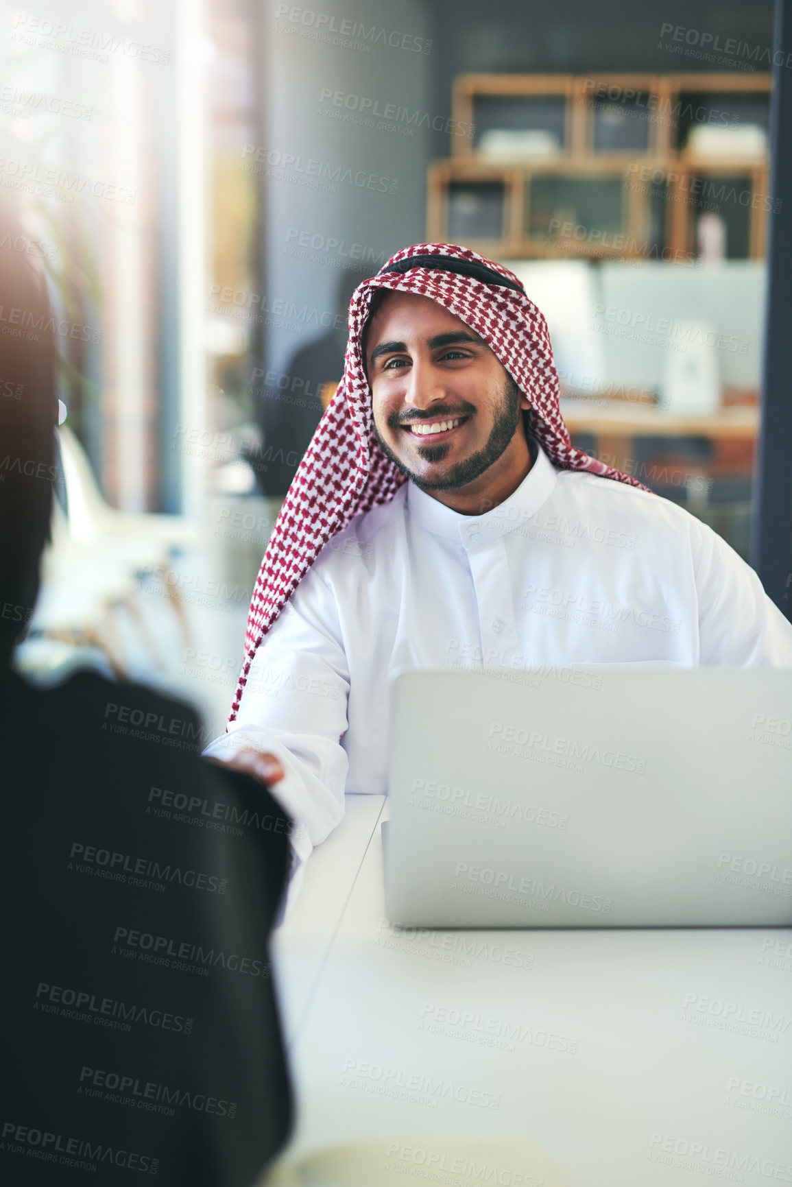 Buy stock photo Handshake, businessman and muslim in office for hiring, merger or partnership as corporate consultant. Male person, Arabic and laptop with agreement, deal or contract in finance agency for teamwork