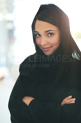 Buy stock photo Portrait of a confident young muslim businesswoman working in a modern office