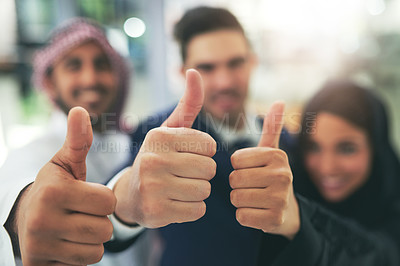 Buy stock photo Portrait of a team of colleagues showing thumbs up in an arabic office