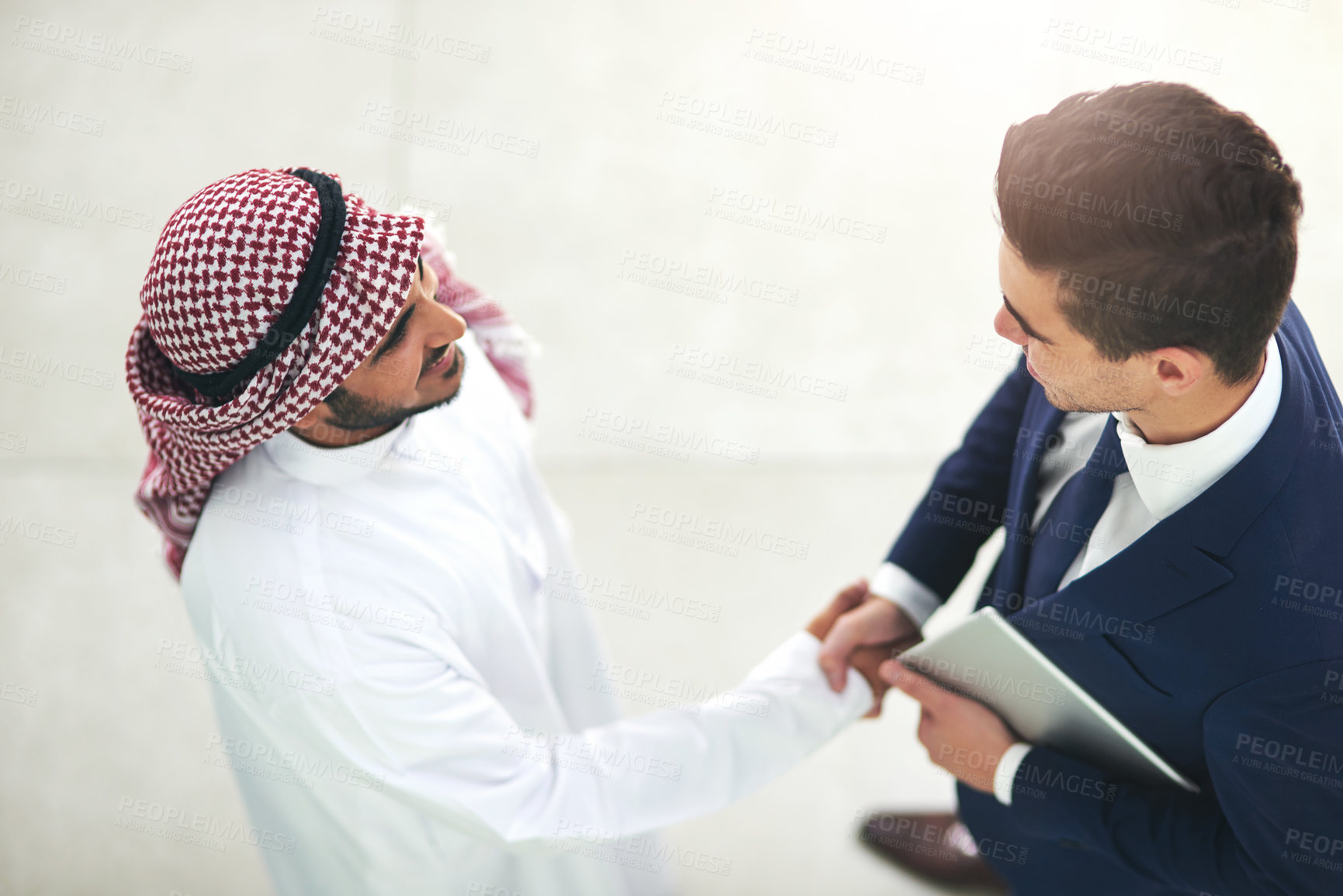 Buy stock photo Businessman, handshake and meeting with arab person above for dubai deal, agreement or negotiation at office. Top view of muslim man shaking hands for b2b, partnership or introduction at workplace