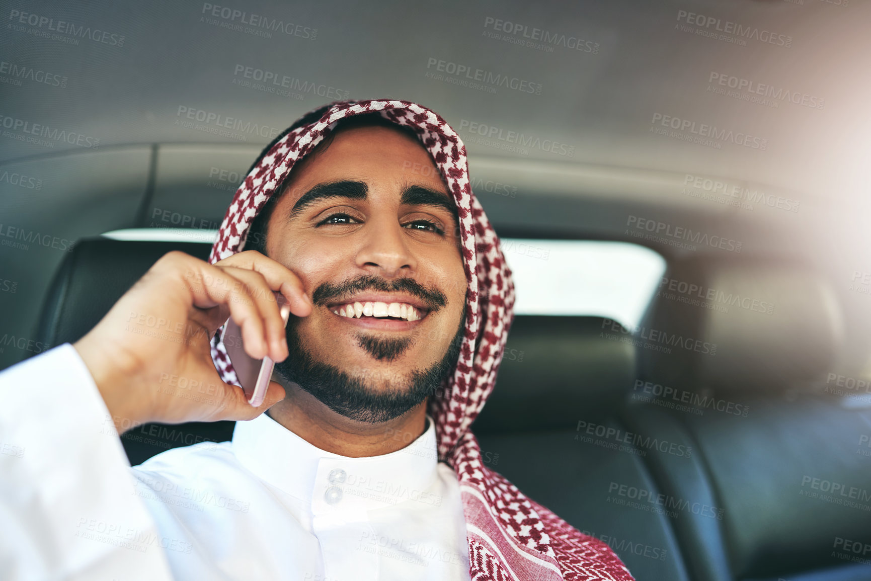 Buy stock photo Muslim man, business and phone call in car for travel, journey or commute to work trip in transport. Islam, taxi and happy passenger on mobile for deal, schedule or listening to news in Saudi Arabia