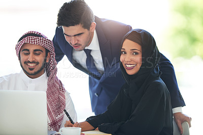 Buy stock photo Portrait of a team of muslim coworkers using a laptop together in a modern office