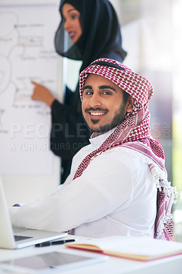 Buy stock photo Portrait of a young muslim businessman sitting in on a presentation with his colleague at work