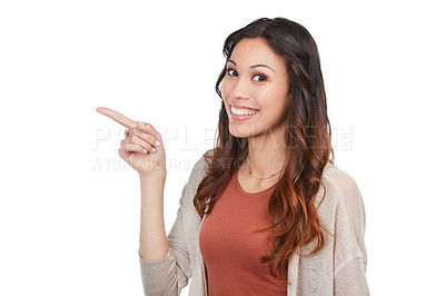 Buy stock photo Portrait of a confident young woman pointing at blank copyspace in studio