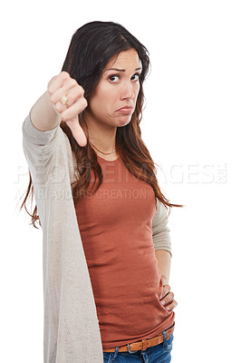 Buy stock photo Portrait of an unhappy young woman showing a thumbs down in studio