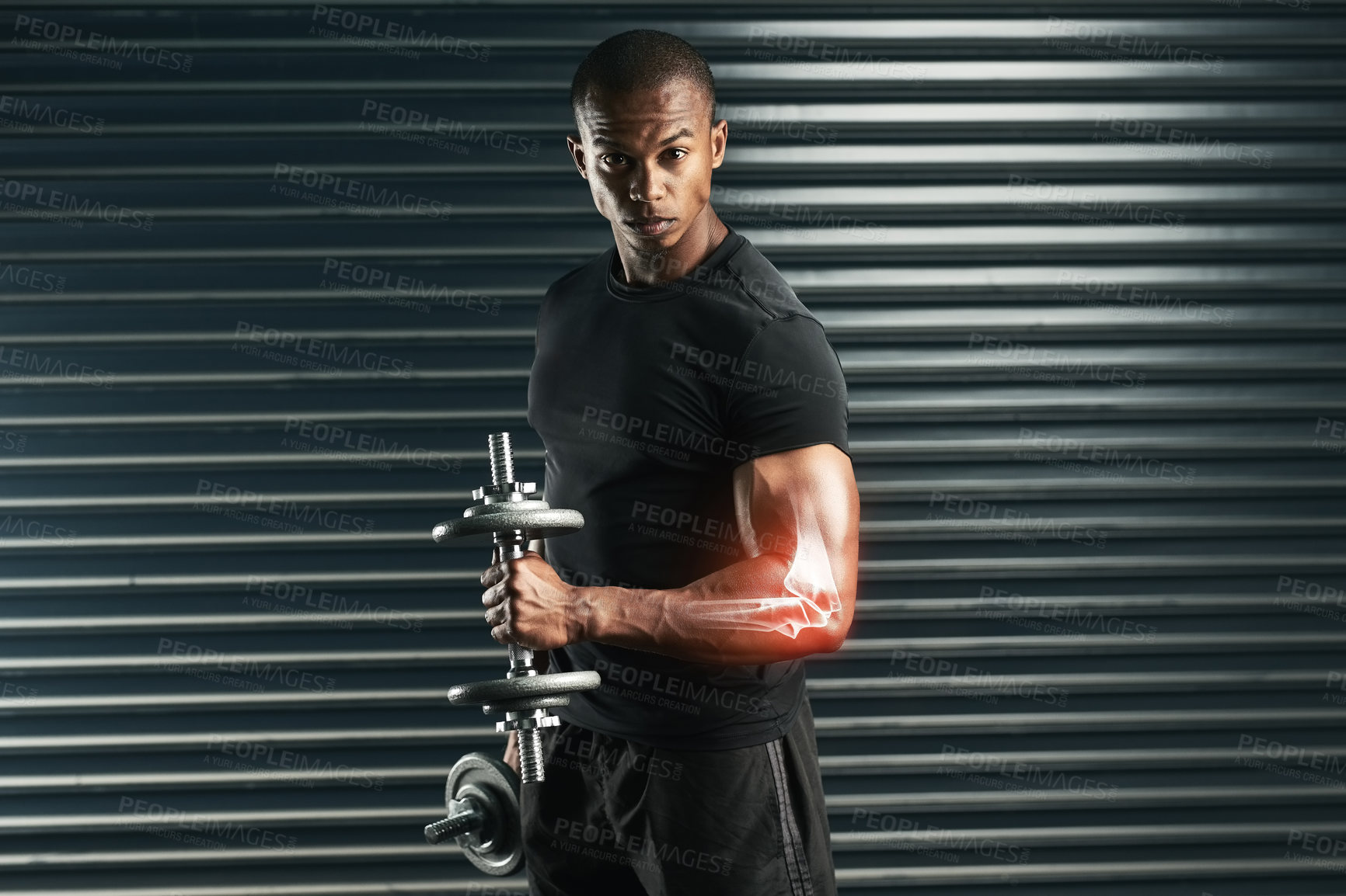Buy stock photo Cropped portrait of an athletic young man working out with a dumbbell in the studio