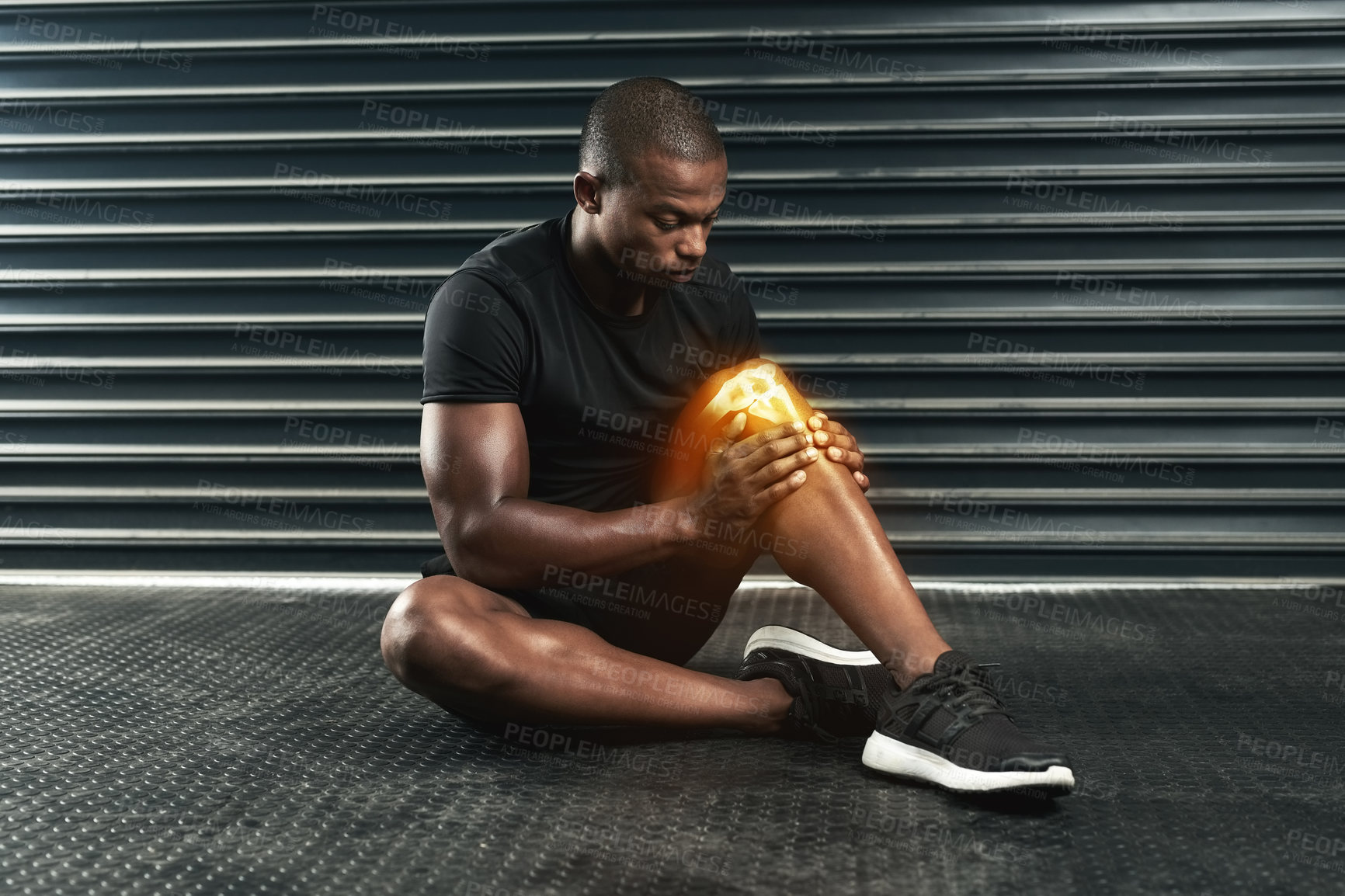 Buy stock photo Studio shot of an athletic young man examining a knee injury during his workout