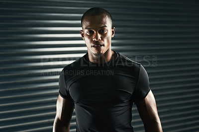 Buy stock photo Cropped portrait of a handsome and athletic young man posing in the studio