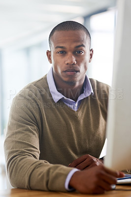 Buy stock photo Portrait of a handsome young businessman working in his office