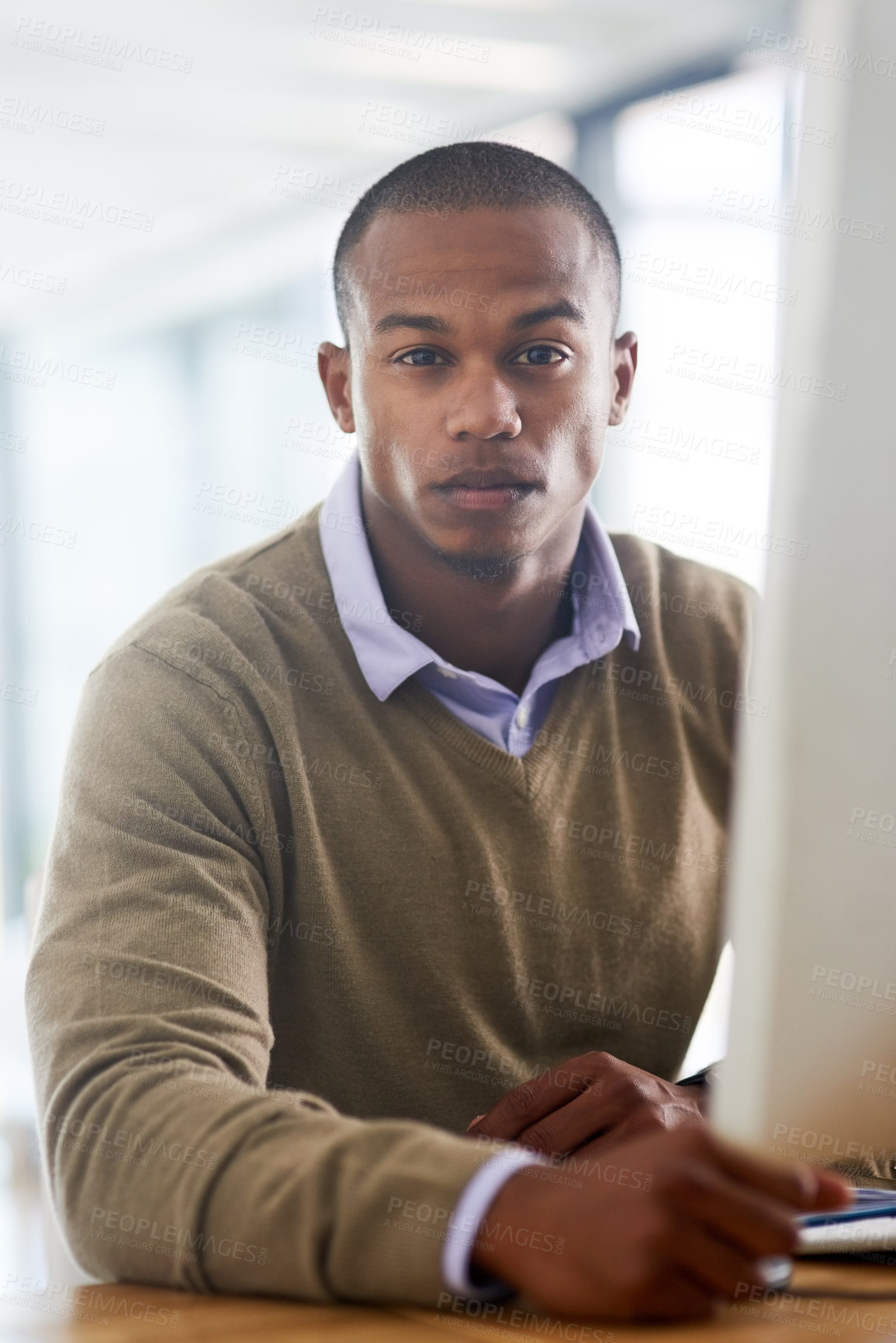 Buy stock photo Portrait of a handsome young businessman working in his office