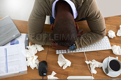 Buy stock photo High angle shot of a young businessman feeling ill at his work desk