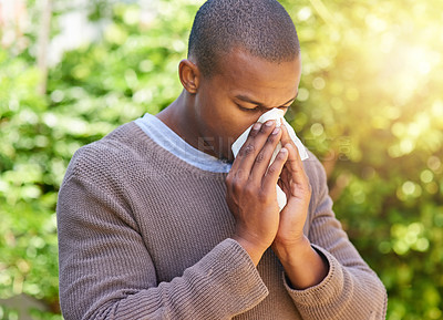 Buy stock photo Blowing nose, hay fever and allergy with black man in park for spring, virus and sickness. Illness, spring and wellness with male person and tissue in nature for allergies, flu and congestion