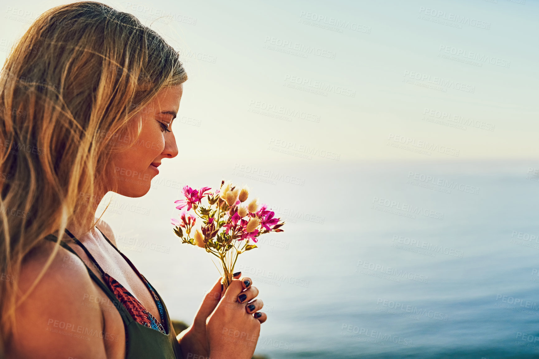 Buy stock photo Girl, flowers and mountain for ocean view in outdoor, travel and bouquet arrangement for peace. Female person, calm and sea for tranquility on vacation in nature, weekend trip for zen or plants