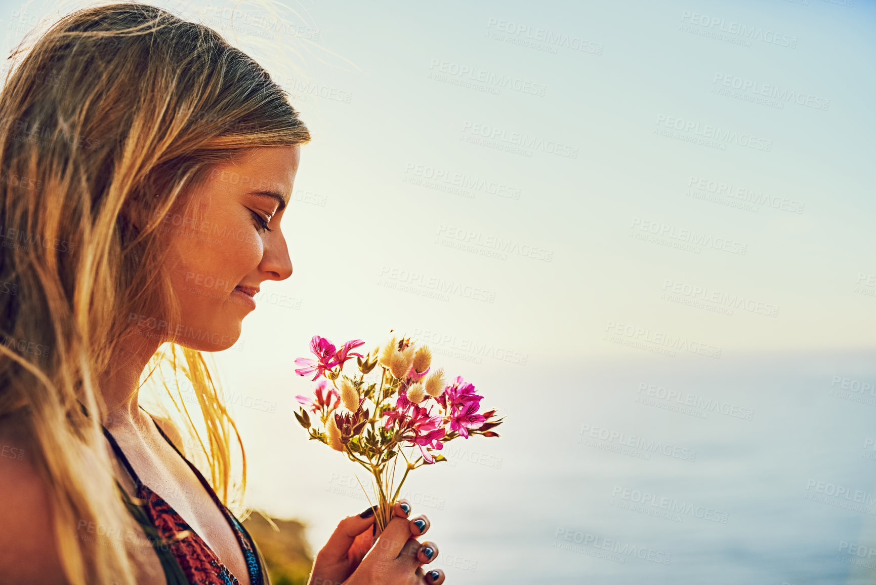 Buy stock photo Girl, flowers and mountain for sea view in outdoor, travel and bouquet arrangement for peace. Female person, calm and water for tranquility on vacation in nature, weekend trip and profile or plants