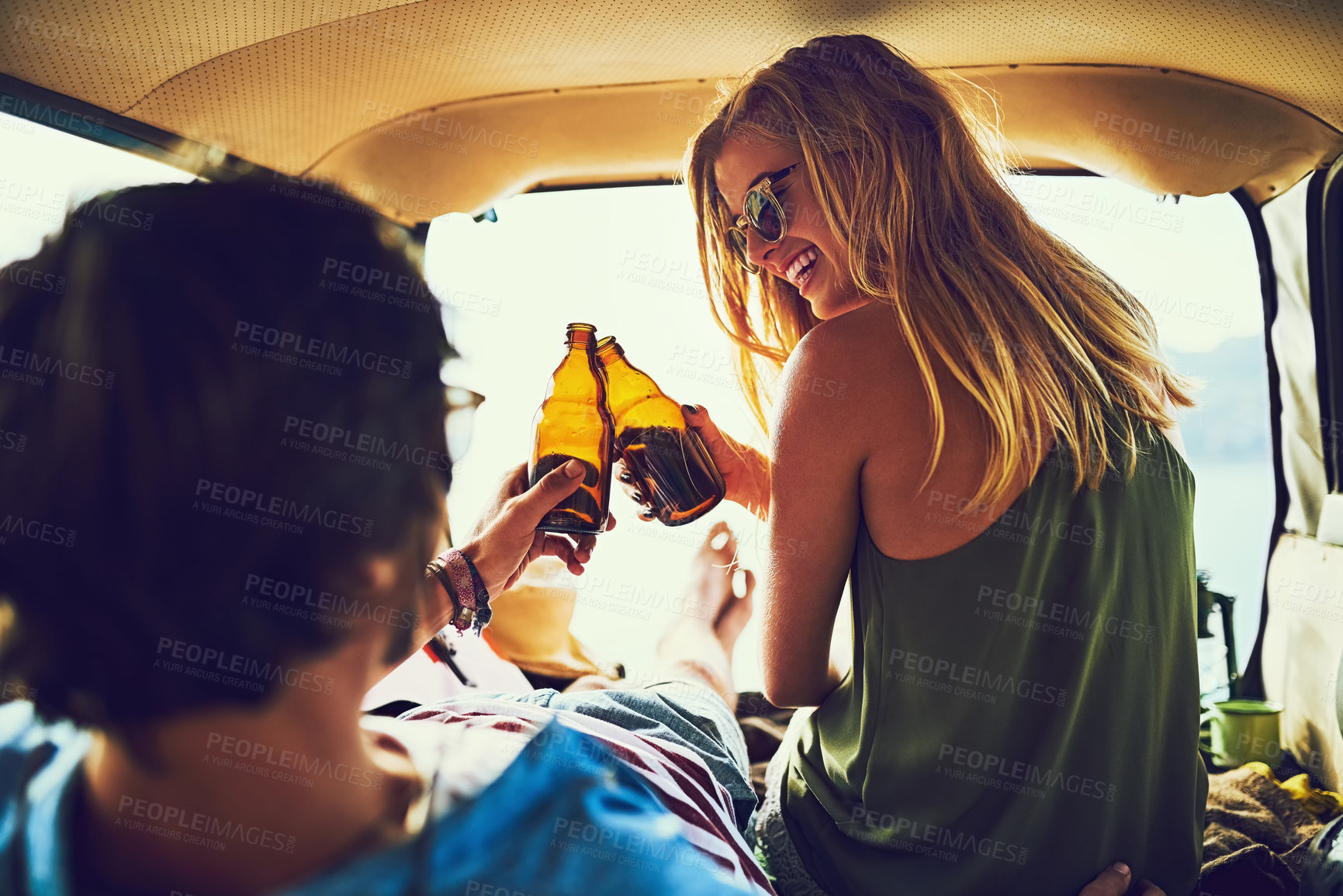 Buy stock photo Rearview shot of a young couple relaxing inside their car during a roadtrip