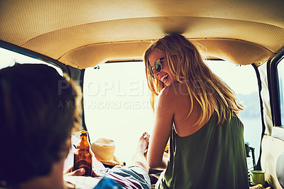 Buy stock photo Rearview shot of a young couple relaxing inside their car during a roadtrip