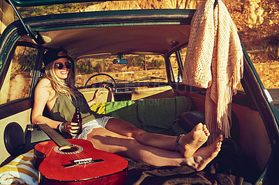 Buy stock photo Shot of a young woman relaxing in the back of her car  on a roadtrip