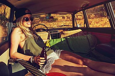Buy stock photo Shot of a young woman relaxing in the back of her car  on a roadtrip