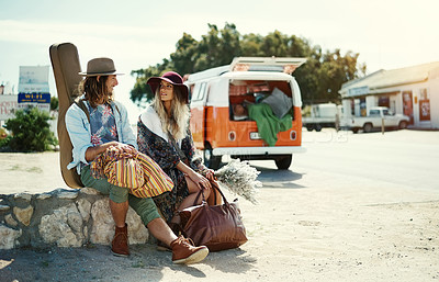 Buy stock photo Shot of a young hipster couple sitting at the side of the road with their broken down van in the background