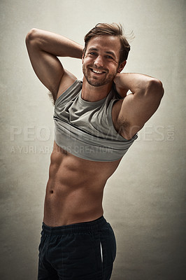 Buy stock photo A handsome and muscular young man posing in the studio