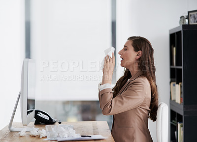 Buy stock photo Shot of a young businesswoman suffering with allergies at work