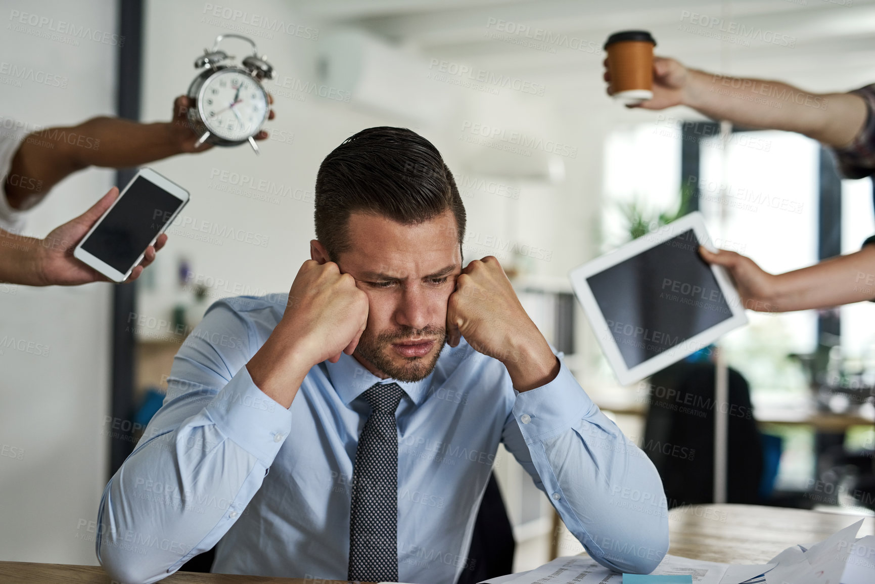 Buy stock photo Shot of a stressed out businessman surrounded by demanding colleagues in an office