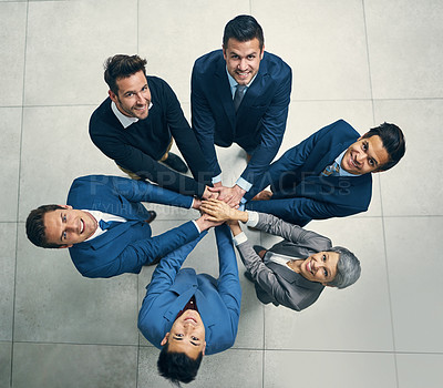 Buy stock photo Portrait of a group of businesspeople joining their hands together in unity