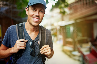 Buy stock photo Portrait of a smiling young man wearing a backpack traveling in Thailand