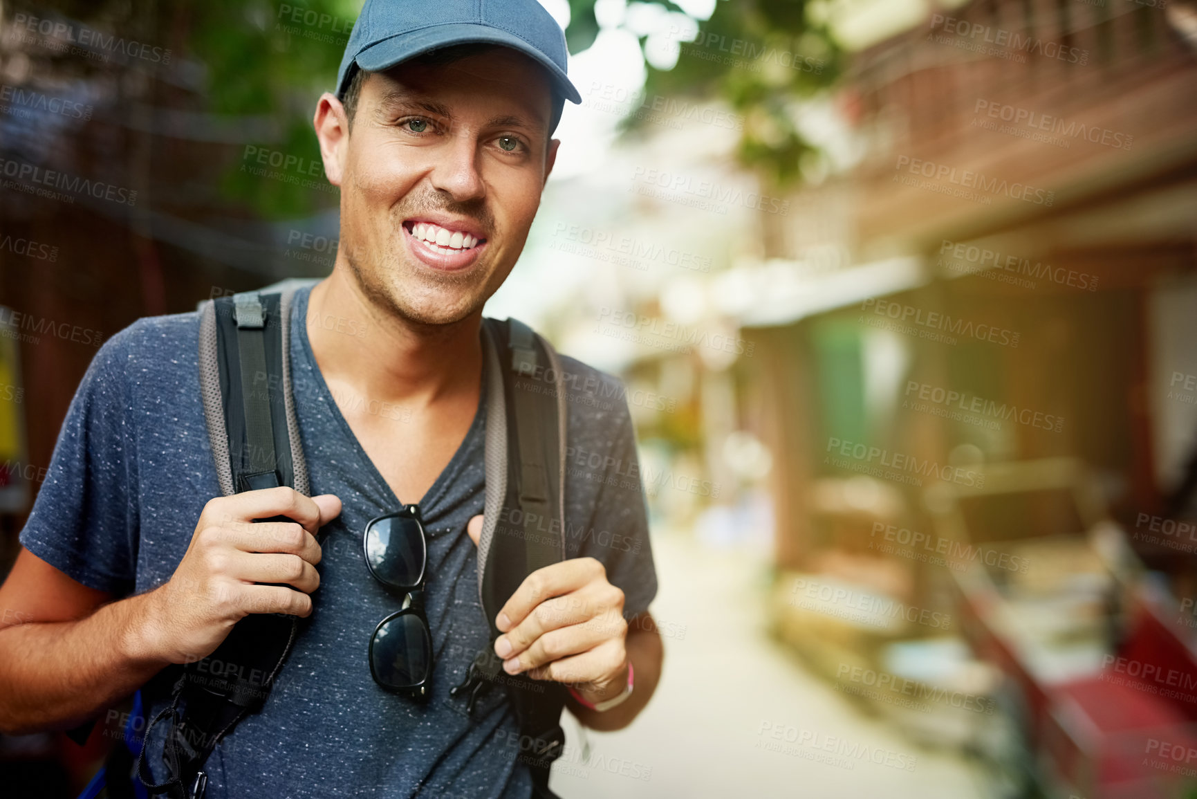 Buy stock photo Portrait of a smiling young man wearing a backpack traveling in Thailand