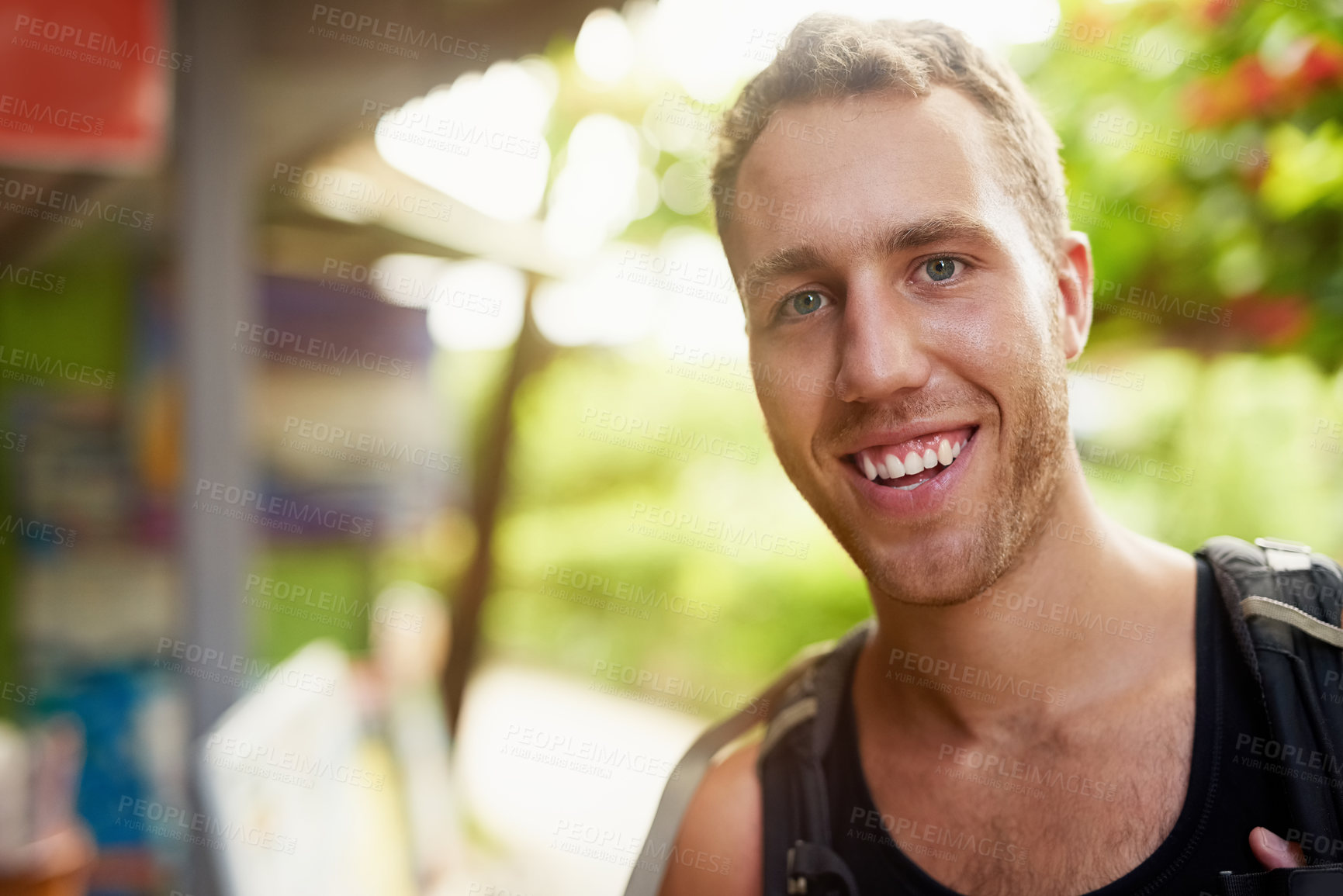 Buy stock photo Portrait of a smiling young man wearing a backpack traveling in Thailand