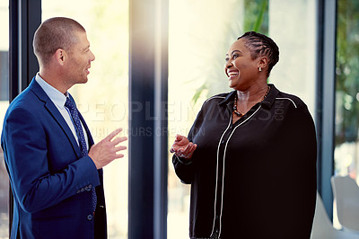 Buy stock photo Shot of two businesspeople having a discussion in an office
