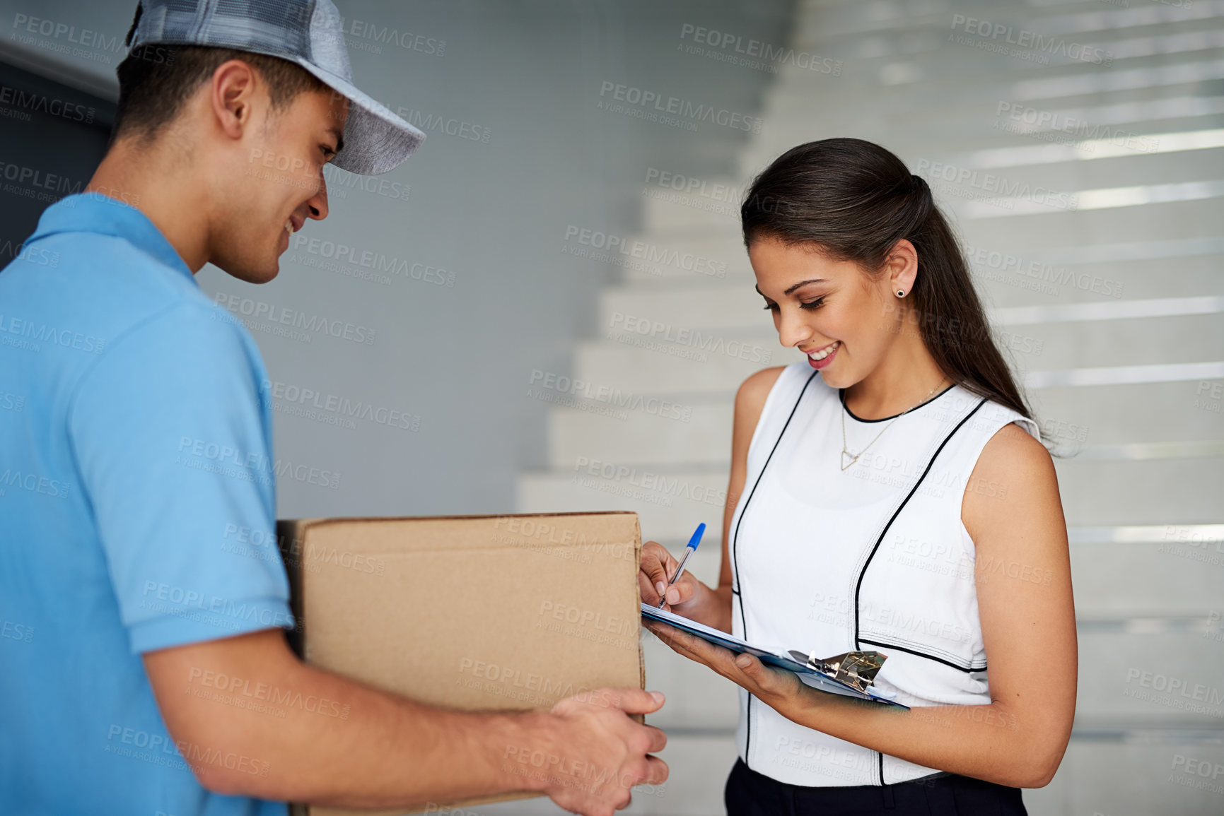 Buy stock photo Cropped shot of a businesswoman signing for her package from the courier