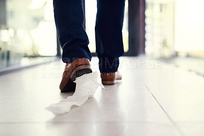 Buy stock photo Closeup shot of a businessman walking in an office with toilet paper stuck to his shoe
