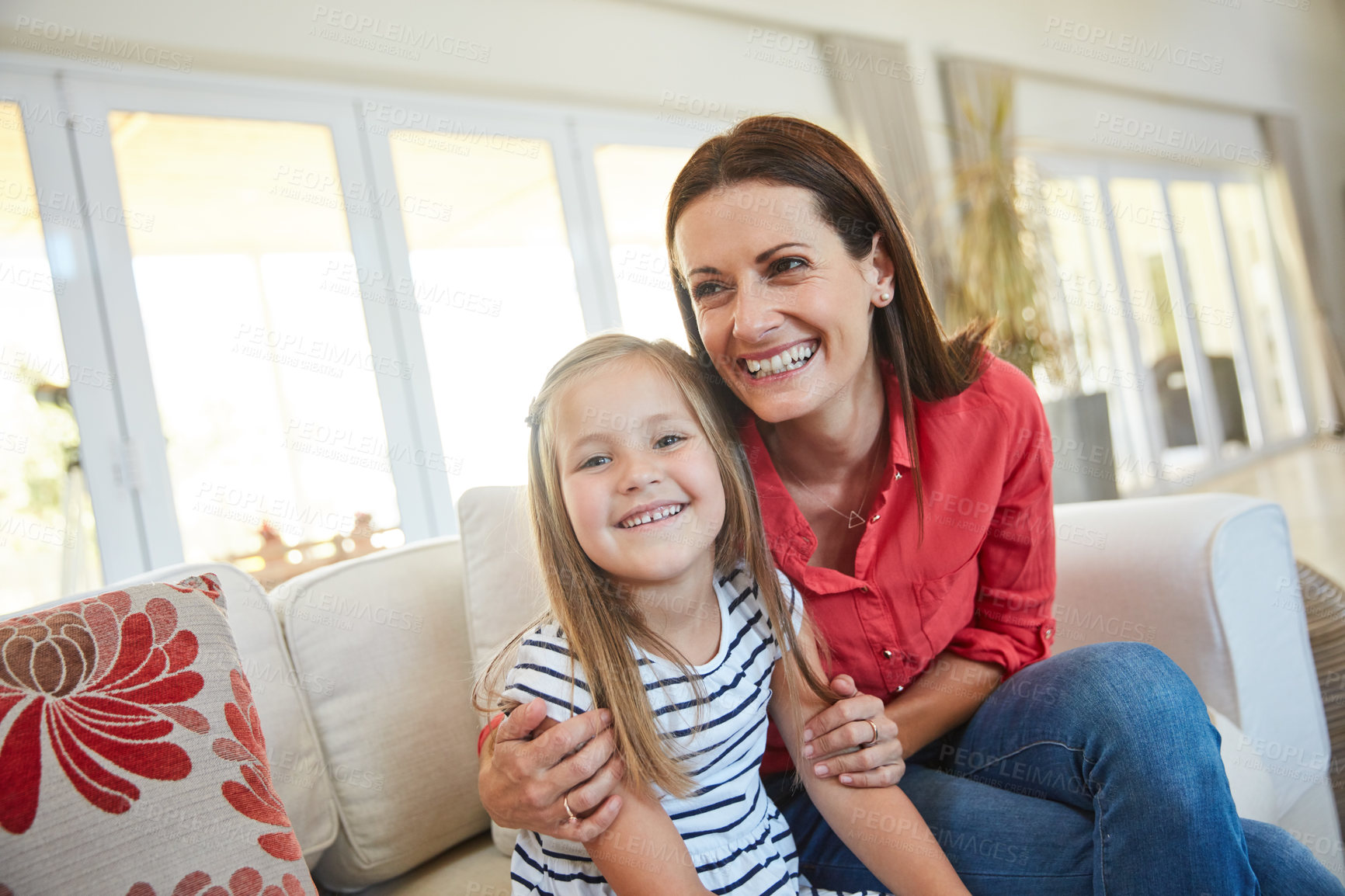 Buy stock photo Portrait of a mother and  her young daughter sitting together in the living room at home